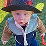 toddler, child, hat, spiderman, jacket, outdoor, grass, toy, shovel, boots, blue_eyes, curious, standing, sunlight, casual_clothing, playtime, fall, young_child, portrait, daytime