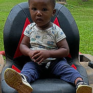 Jeremiah joined the competition — help win amazing prizes! toddler, child, seat, craftsman, lawn_mower, outdoor, grass, trees, shoes, clothing, greenery, person, baby, portrait, sitting, nature, daylight, casual, lawn, young_child