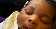 Xzayvion joined the competition — help win amazing prizes! baby, sleeping, blanket, hand, closeup, infant, child, soft, cozy, peaceful, face, portrait, indoors, dark_skin, curly_hair, resting, wrapped, warm, toddler, cute