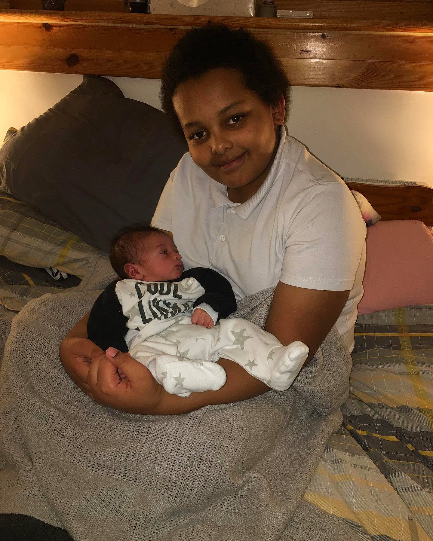 Bailey Nixon joined the competition — help win amazing prizes! abdomen, baby, child, comfort, couch, elbow, face, facial_expression, human_body, joy, lap, leg, mouth, muscle, person, room, sitting, skin, smile, thigh