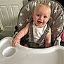 baby, child, high_chair, smiling, happy, blue_eyes, white_tank_top, straps, indoor, door, carpet, plastic_tray, star_pattern, seat, furniture, person, cute, infant, portrait, hand