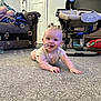baby, child, crawling, carpet, bubbles, indoor, sofa, person, baby_rocker, door, floor, smiling, clothing, head, hand, toy, furniture, living_room, happy, home