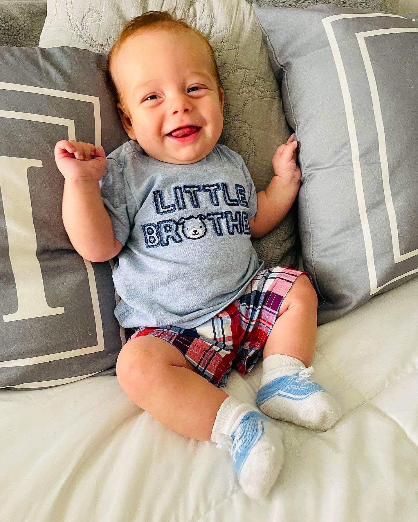 Cassius is registered to the contest to win money with this photo: arm, baby_toddler_clothing, comfort, couch, eye, face, facial_expression, finger, happy, head, joint, joy, leg, mouth, person, shoulder, skin, sleeve, smile, textile