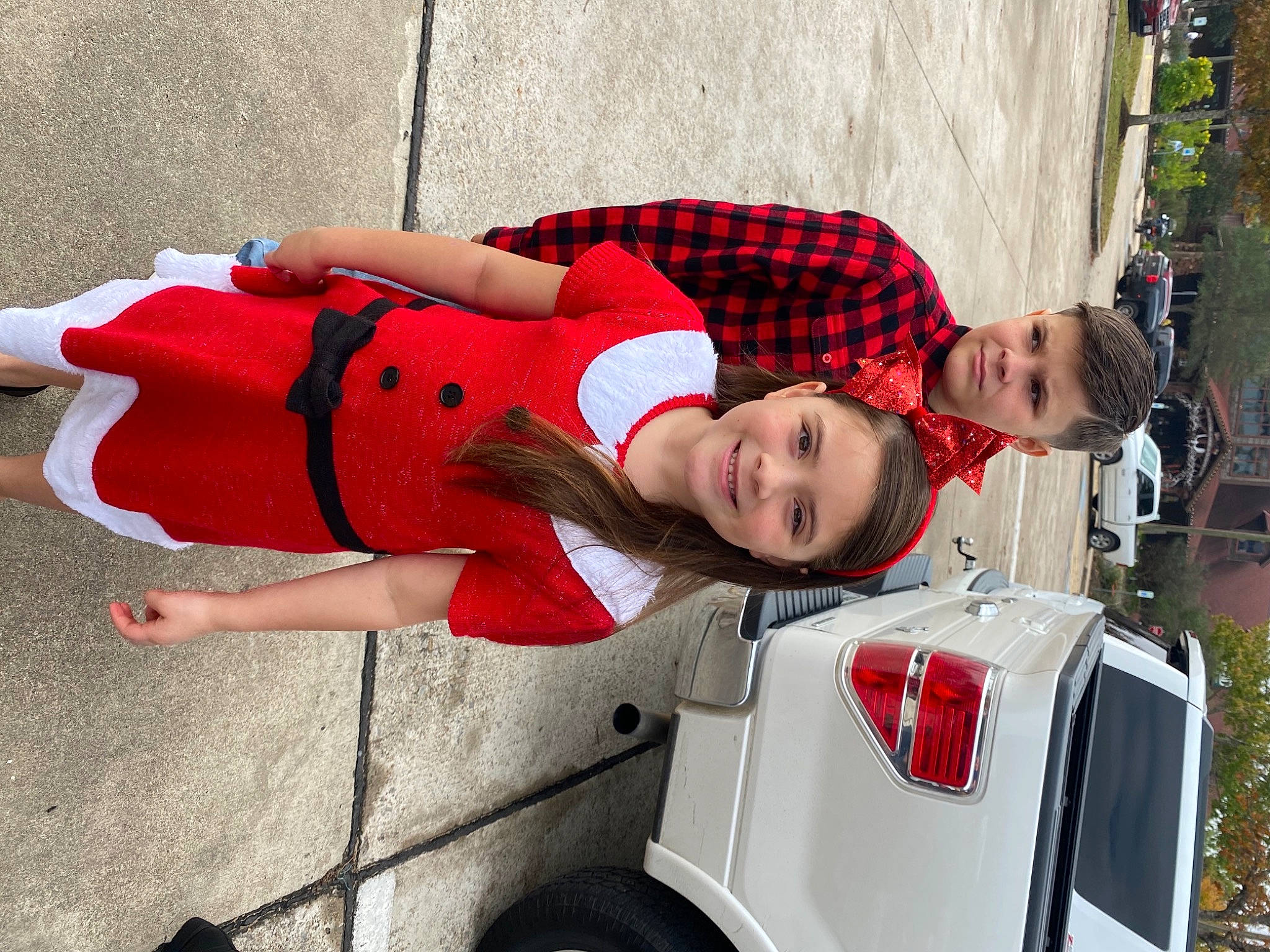 Allie is registered to the contest to win money with this photo: automotive_design, automotive_exterior, automotive_lighting, automotive_tail_brake_light, automotive_tire, bumper, car, face, fender, fun, human_leg, joy, motor_vehicle, person, red, street_fashion, thigh, tire, tree, trunk