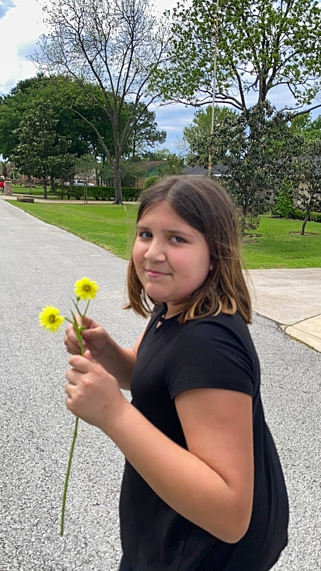 Amber is registered to the contest to win money with this photo: annual_plant, botany, eye, flower, flowering_plant, fun, grass, hand, happy, joy, leaf, leisure, long_hair, people_in_nature, person, petal, plant, recreation, rose, sky