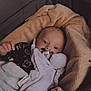 baby, blanket, pacifier, infant, sleeping_bag, cute, cozy, soft, clothing, newborn, child, face, resting, indoors, warm, hands, head, comfort, carrying_bag, portrait
