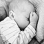 baby, sleeping, infant, blanket, cozy, black_and_white, close_up, soft_texture, peaceful, child, newborn, cute, face, hand, clothing, portrait, resting, toddler, warm, comfort