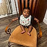 Atlas joined the competition — help win amazing prizes! baby, child, infant, portrait, sitting, chair, vintage_chair, bib, clothing, curious, indoors, home, wood_floor, curtains, furniture, brown_tones, black_shirt, bare_feet, looking_at_camera, smiling