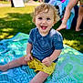 Maddox joined the competition — help win amazing prizes! toddler, child, smiling, blue_eyes, curly_hair, sitting, outdoor, grass, blanket, yellow_shorts, blue_shirt, daylight, park, happy, drool, person, summer, barefoot, play, nature