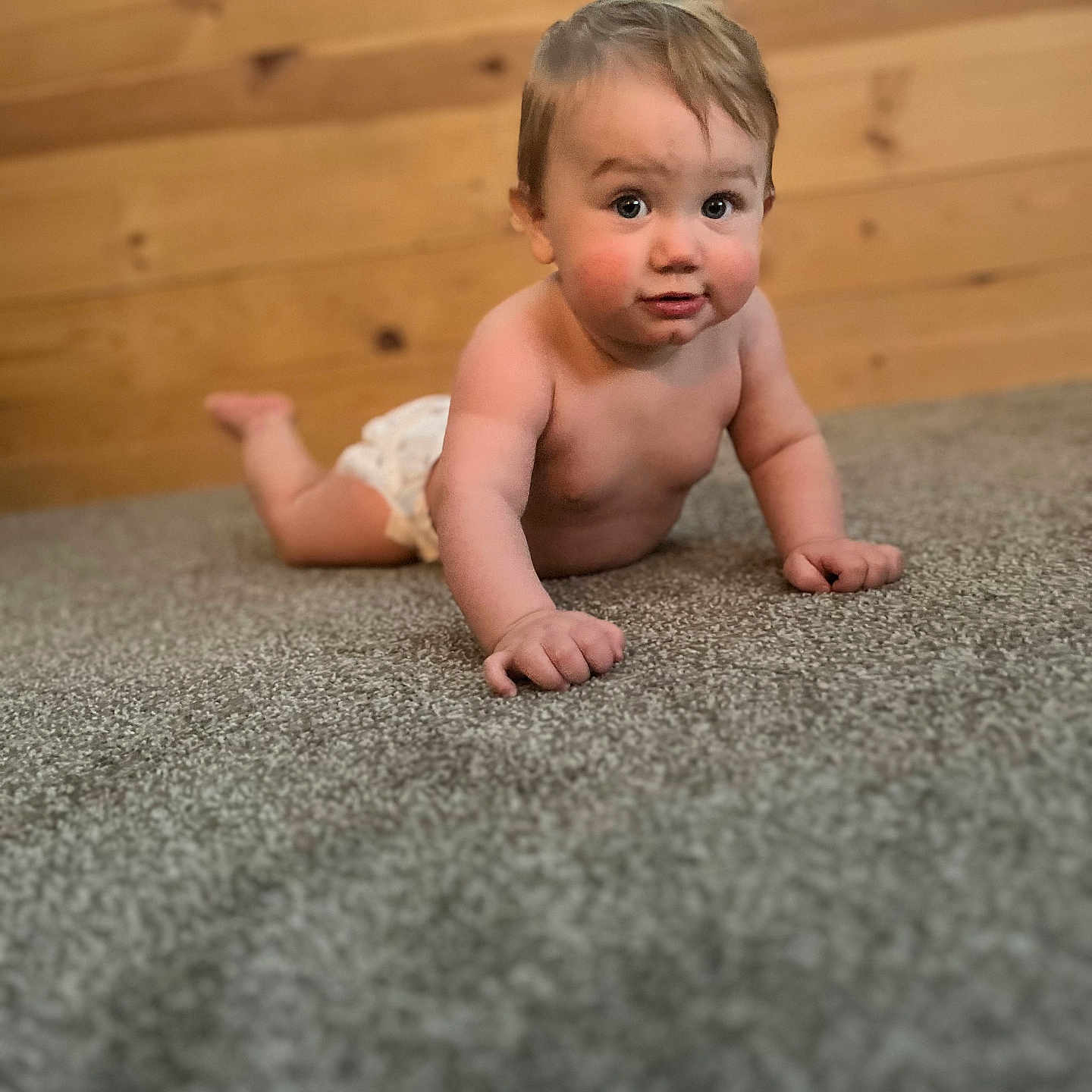 Maddox joined the competition — help win amazing prizes! baby, carpet, child, chubby_cheeks, crawling, curious, cute, diaper, expression, floor, home, indoor, infant, natural_light, person, playful, portrait, skin, wooden_wall, young_child