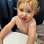 Maddox is registered to the contest to win money with this photo: toddler, child, blond_hair, blue_eyes, smiling, happy, indoor, curly_hair, bare_chest, bathroom, white_surface, curtain, shadow_figures, rug, floor_tiles, portrait, closeup, cute, playful, person
