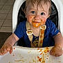 toddler, child, high_chair, messy, baby_food, face, hands, blue_eyes, clothing, feeding_time, indoor, expression, cute, smile, hair, tray, food, seat, straps, person