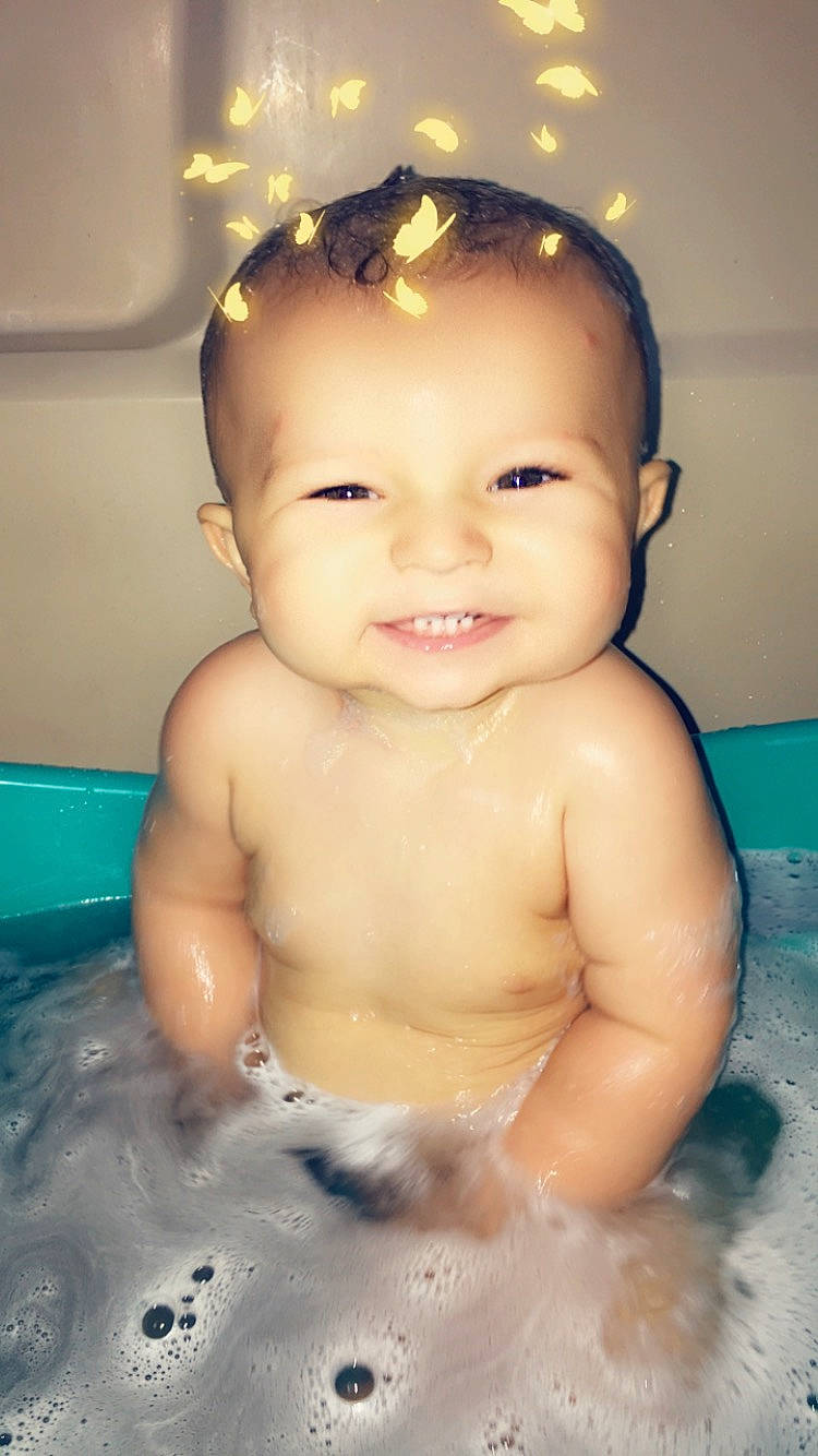 Kai is registered to the contest to win money with this photo: baby, baby_bathing, bathing, bathtub, cheek, child, chin, eye, eyebrow, face, facial_expression, forehead, fun, head, joy, muscle, person, skin, smile, toddler