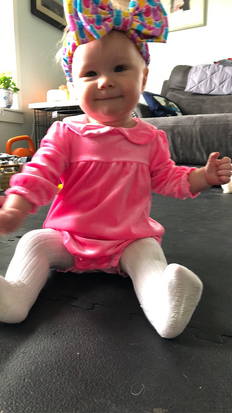 Helena joined the competition — help win amazing prizes! baby, baby_toddler_clothing, child, comfort, couch, facial_expression, flowerpot, fun, happy, headwear, houseplant, joy, knee, magenta, person, pink, plant, red, shorts, sleeve