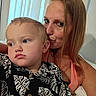 Chaos is registered to the contest to win money with this photo: affection, blinds, bond, candid, casual_clothing, child, closeup, expression, face, family, hair, human, indoor, kiss, love, person, portrait, skin, toddler, woman