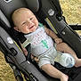 baby, car_seat, bottle, outdoor, grass, onesie, smiling, child, infant, seatbelt, happy, cactus, milk, foot, hand, person, clothing, baby_bottle, seat, resting
