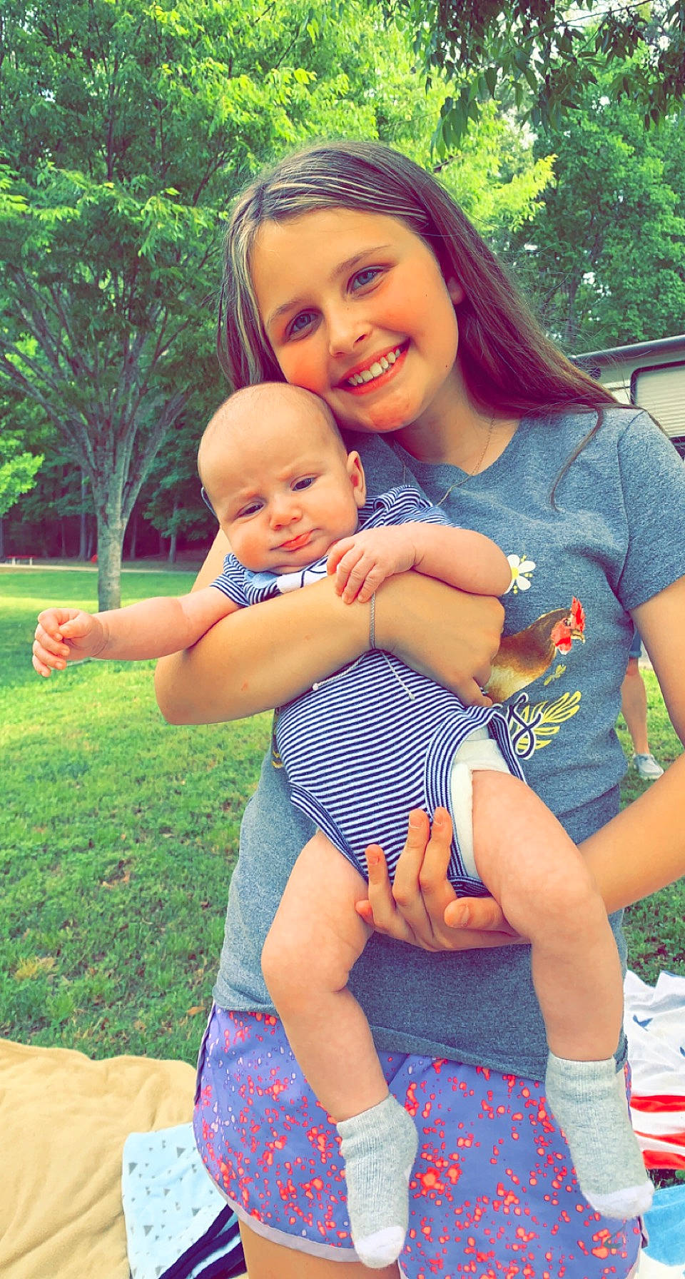 Kimberly is registered to the contest to win money with this photo: arm, eye, face, facial_expression, finger, gesture, grass, hairstyle, happy, head, joy, leisure, people_in_nature, person, pink, plant, shorts, smile, summer, t_shirt
