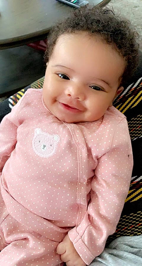 Santana is registered to the contest to win money with this photo: baby_toddler_clothing, cheek, dress, eye, eyebrow, eyelash, face, forehead, hair, happy, head, iris, joy, lip, nose, outerwear, person, pink, skin, sleeve