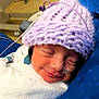 aircraft, airplane, architecture, baby, beanie, bonnet, building, cap, clothing, face, glove, hat, head, hospital, newborn, person, photography, purple, transportation, vehicle