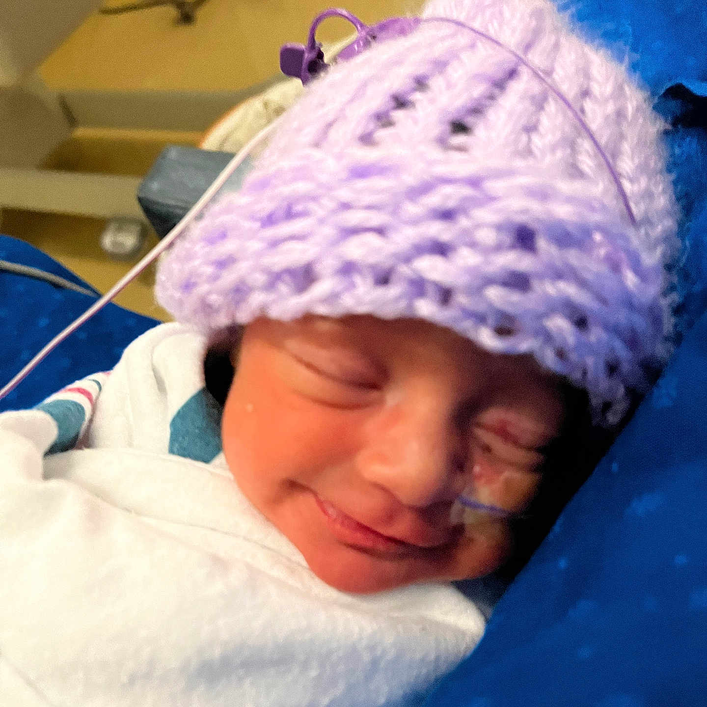 Isabella joined the competition — help win amazing prizes! aircraft, airplane, architecture, baby, beanie, bonnet, building, cap, clothing, face, glove, hat, head, hospital, newborn, person, photography, purple, transportation, vehicle