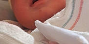 Mylo is registered to the contest to win money with this photo: baby, blanket, child, closeup, clothing, cozy, cute, face, hat, indoors, infant, newborn, newborn_baby, person, portrait, resting, skin, sleepy, soft, wrapped