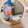 Naël a rejoint le concours — aidez-le/la à gagner de superbes lots ! baby, blanket, carpet, child, crawling, decor, eye_contact, face, furniture, hand, home, indoor, mirror, portrait, reflection, rug, smile, surprised_expression, toy, wicker_frame