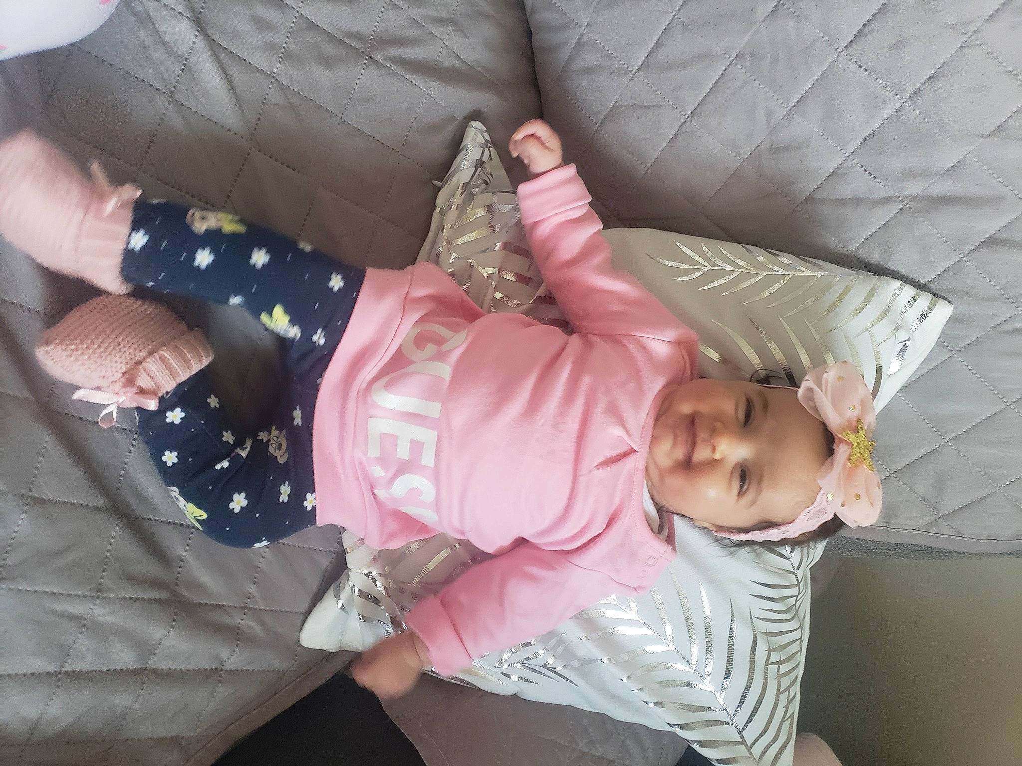 Emily participe au concours pour gagner de l'argent avec cette photo : baby, baby_products, baby_toddler_clothing, child, comfort, finger, headwear, joy, lap, linens, magenta, nail, pattern, person, pink, product, sitting, sleeve, smile, textile