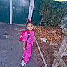 Mady a rejoint le concours — aidez-le/la à gagner de superbes lots ! child, girl, pink_clothing, backpack, sidewalk, leaves, tree, green_gate, autumn, outdoor, casual_pose, smiling, hair_bow, sneakers, fence, nature, daylight, young, person, playful