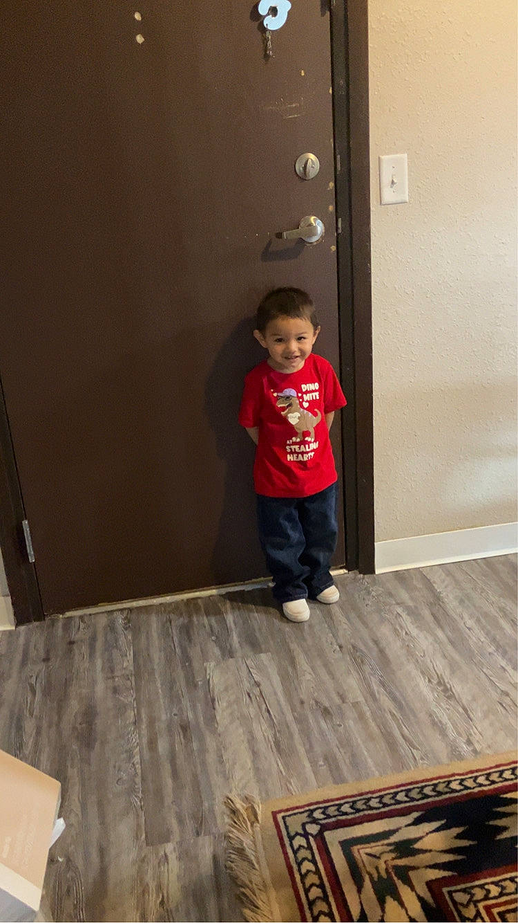 boy, child, clothing, door, face, footwear, hardwood, head, homedecor, indoors, interiordesign, jeans, male, pants, person, photography, plywood, shoe, t_shirt, wood