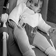 Ines participe au concours pour gagner de l'argent avec cette photo : baby, child, infant, baby_rocker, knitwear, socks, cushion, indoor, seated, face, person, portrait, black_and_white, relaxing, home, furniture, clothing, looking_away, young_child, cozy