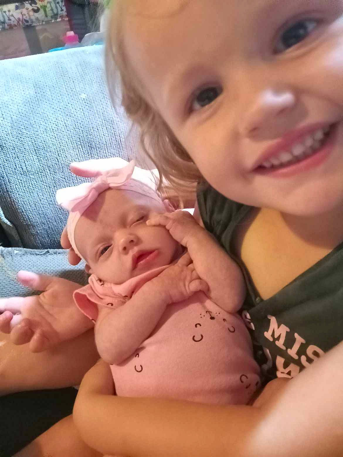 Lindsey is registered to the contest to win money with this photo: arm, baby_toddler_clothing, cheek, eye, face, finger, gesture, happy, head, human_body, joy, lip, mammal, mouth, nail, nose, person, product, skin, smile