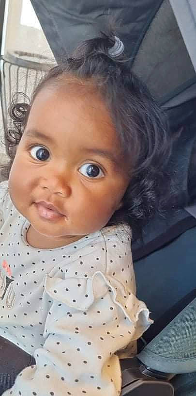 Kamilla participe au concours pour gagner de l'argent avec cette photo : baby, baby_toddler_clothing, black_hair, cheek, chin, dress, eye, eyebrow, eyelash, forehead, head, headgear, iris, lip, mouth, nose, person, skin, sleeve, toddler