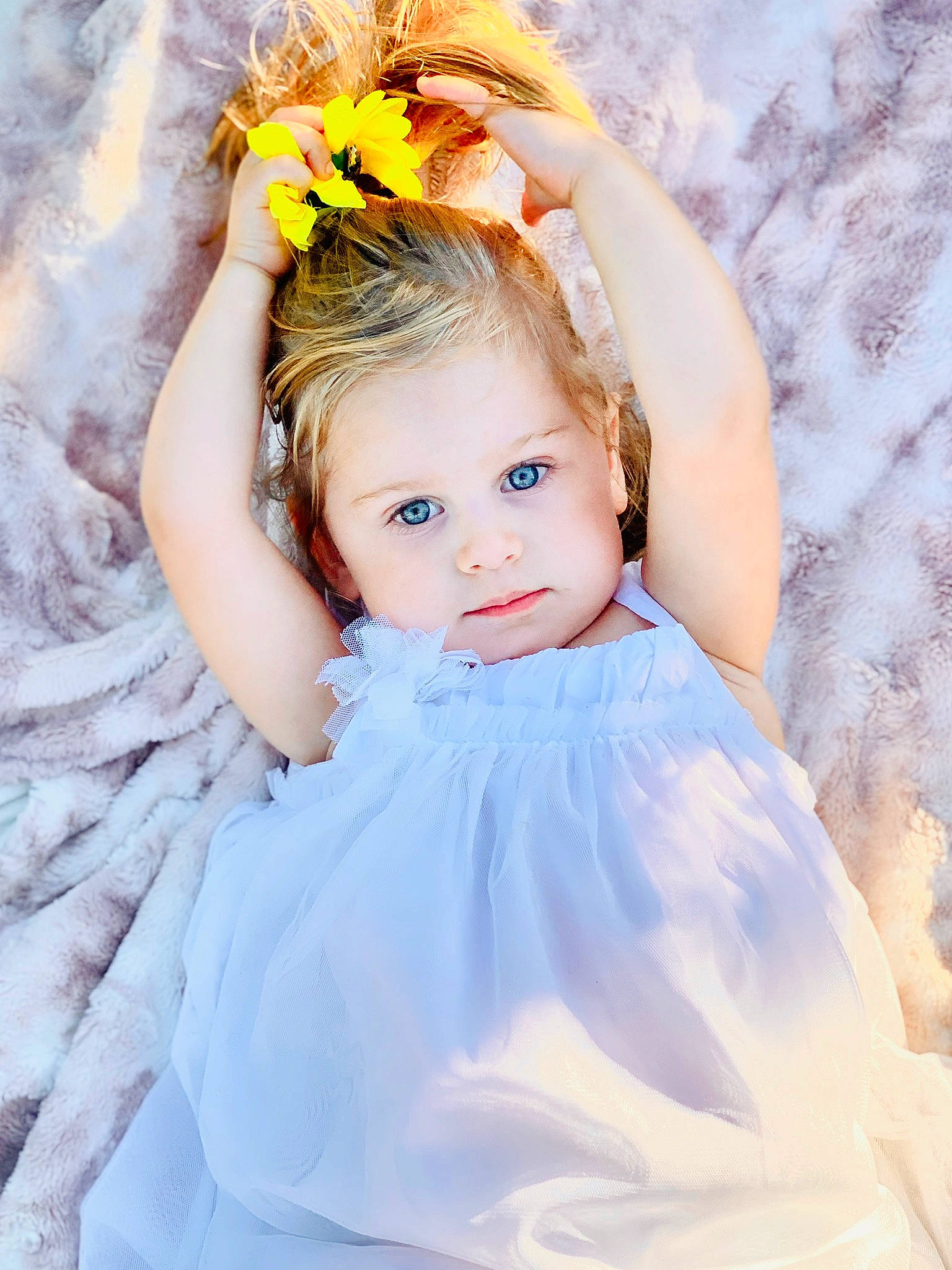 Elizabeth is registered to the contest to win money with this photo: arm, baby_toddler_clothing, bridal_accessory, child, dress, eye, flash_photography, flower, hair, hand, happy, head, headpiece, iris, organ, people_in_nature, person, petal, plant, skin