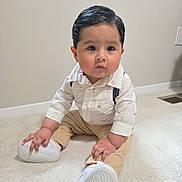 Gael joined the competition — help win amazing prizes! baby, child, toddler, sitting, portrait, indoors, carpet, smiling, serious_expression, slicked_hair, formal_clothing, button_down_shirt, suspenders, beige_pants, white_shoes, sneakers, fashion, floor, wall, home