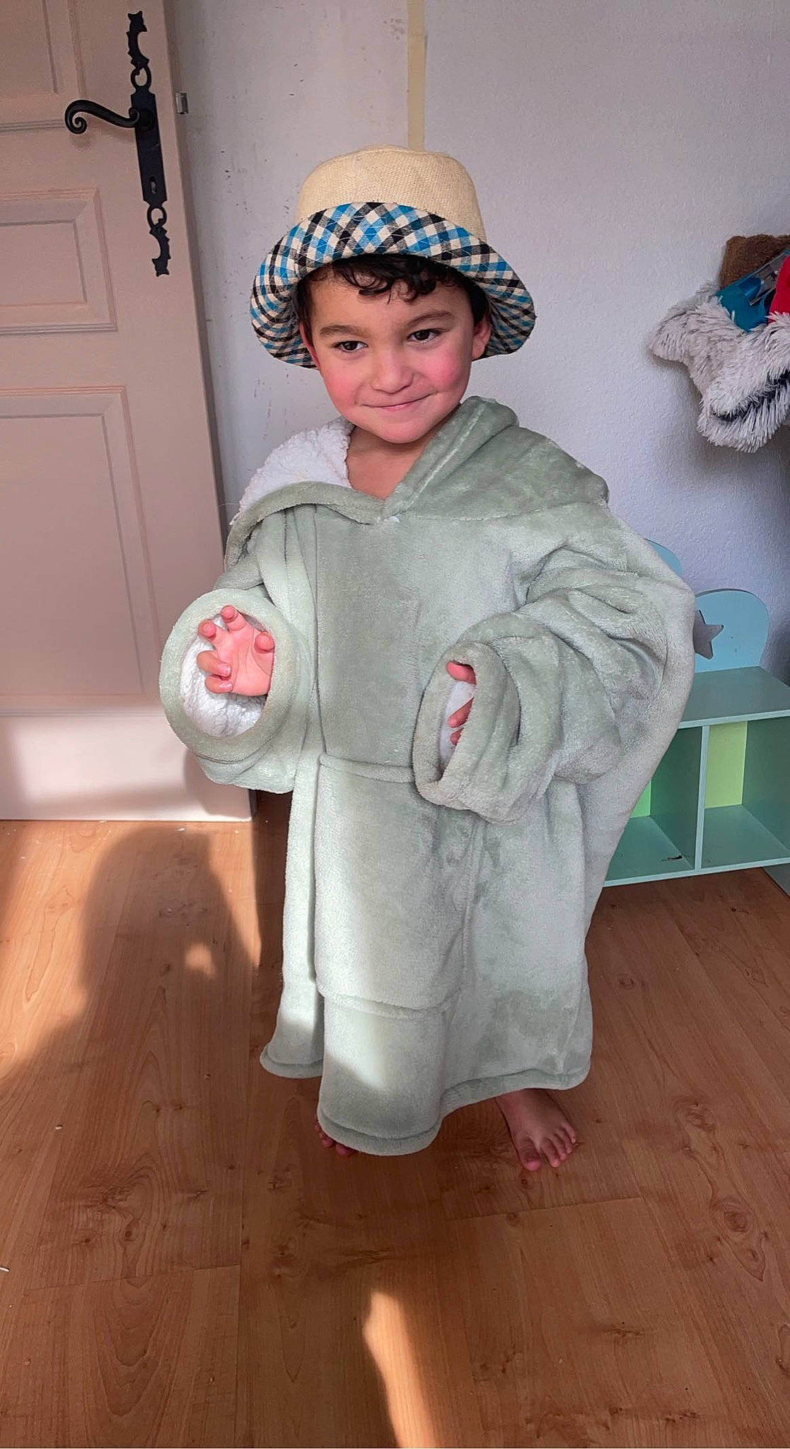 Younis participe au concours pour gagner de l'argent avec cette photo : art, cap, child, costume, costume_hat, door, fashion_accessory, fashion_design, flooring, fun, hardwood, hat, headgear, headwear, joy, person, personal_protective_equipment, room, sleeve, smile