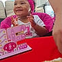 baby, birthday, cake, celebration, child, clapping, decoration, festive, happy, headband, indoor, number_one, party, person, pink, rainbow, smiling, strawberry, table, unicorn