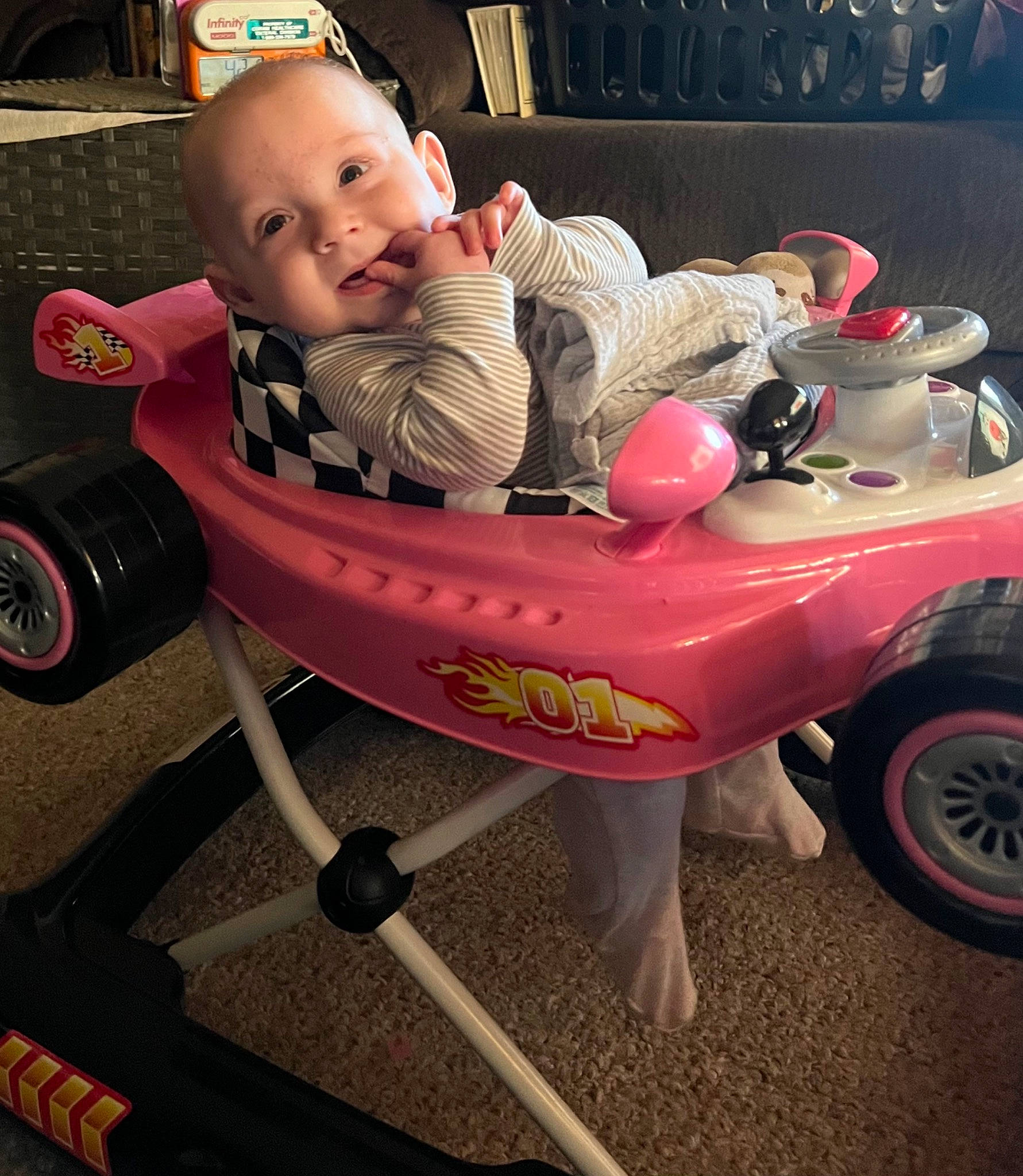 Joie is registered to the contest to win money with this photo: automotive_tire, baby, baby_products, baby_toddler_clothing, child, comfort, fun, happy, head, human_body, motor_vehicle, person, product, riding_toy, sitting, smile, tire, toddler, toy, vehicle
