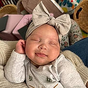 Milana joined the competition — help win amazing prizes! baby, sleeping, headband, bow, cute, infant, smile, cozy, knitwear, child, closeup, face, peaceful, soft_lighting, indoors, person, cuteness, apparel, hand, relaxation