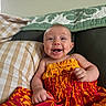 Zephyr joined the competition — help win amazing prizes! baby, smile, happy, child, couch, pillow, clothing, patterned_dress, indoor, person, infant, portrait, seated, colorful, fabric, home, cute, expression, relaxation, cozy