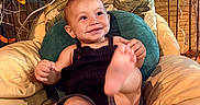 Zephyr joined the competition — help win amazing prizes! baby, child, smiling, cushion, chair, overalls, foot, plush, indoor, decor, green_cushion, leaf, branch, happy, person, portrait, seat, cute, infant, relaxed