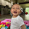 Zephyr joined the competition — help win amazing prizes! baby, smiling, child, indoor, playmat, flower, happy, kitchen, living_room, furniture, toy, floor, ceiling_fan, clothing, home, person, infant, cute, portrait, bright