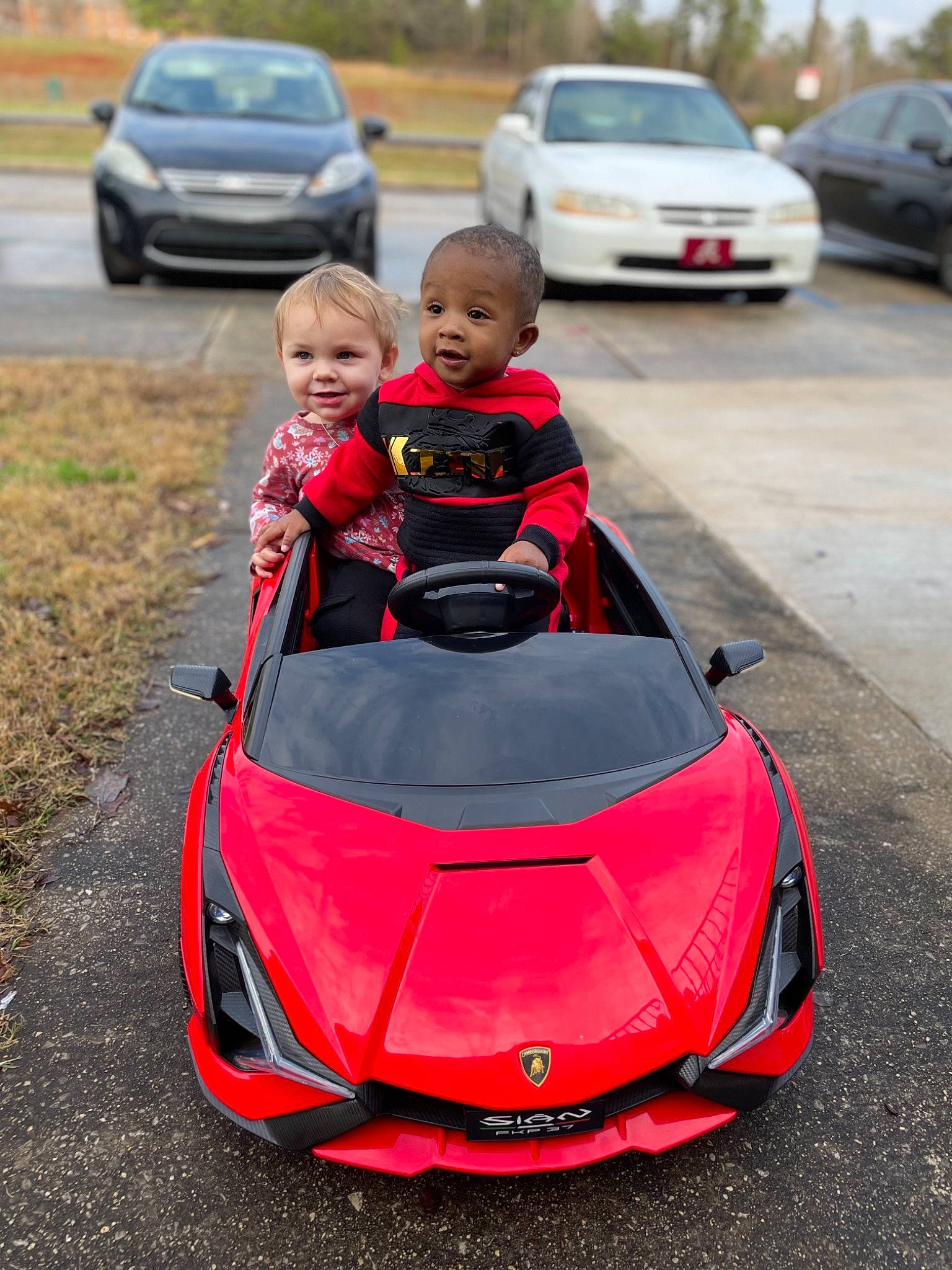 Kingston joined the competition — help win amazing prizes! asphalt, automotive_design, automotive_exterior, automotive_lighting, automotive_tire, automotive_wheel_system, bumper, car, hood, jacket, joy, land_vehicle, motor_vehicle, person, personal_luxury_car, plant, red, rim, smile, toddler