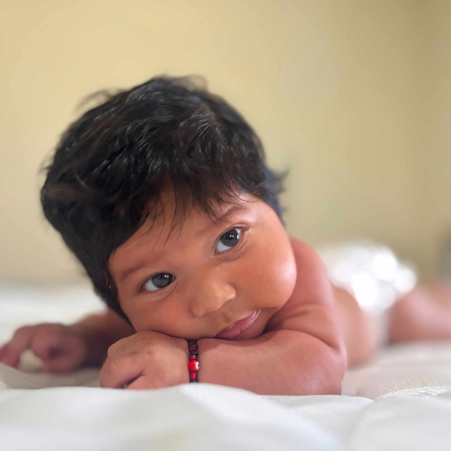Abisai is registered to the contest to win money with this photo: baby, bed, bedroom, blackhair, bodypart, face, finger, furniture, hair, hand, happy, head, indoors, mouth, newborn, person, photography, portrait, room, smile