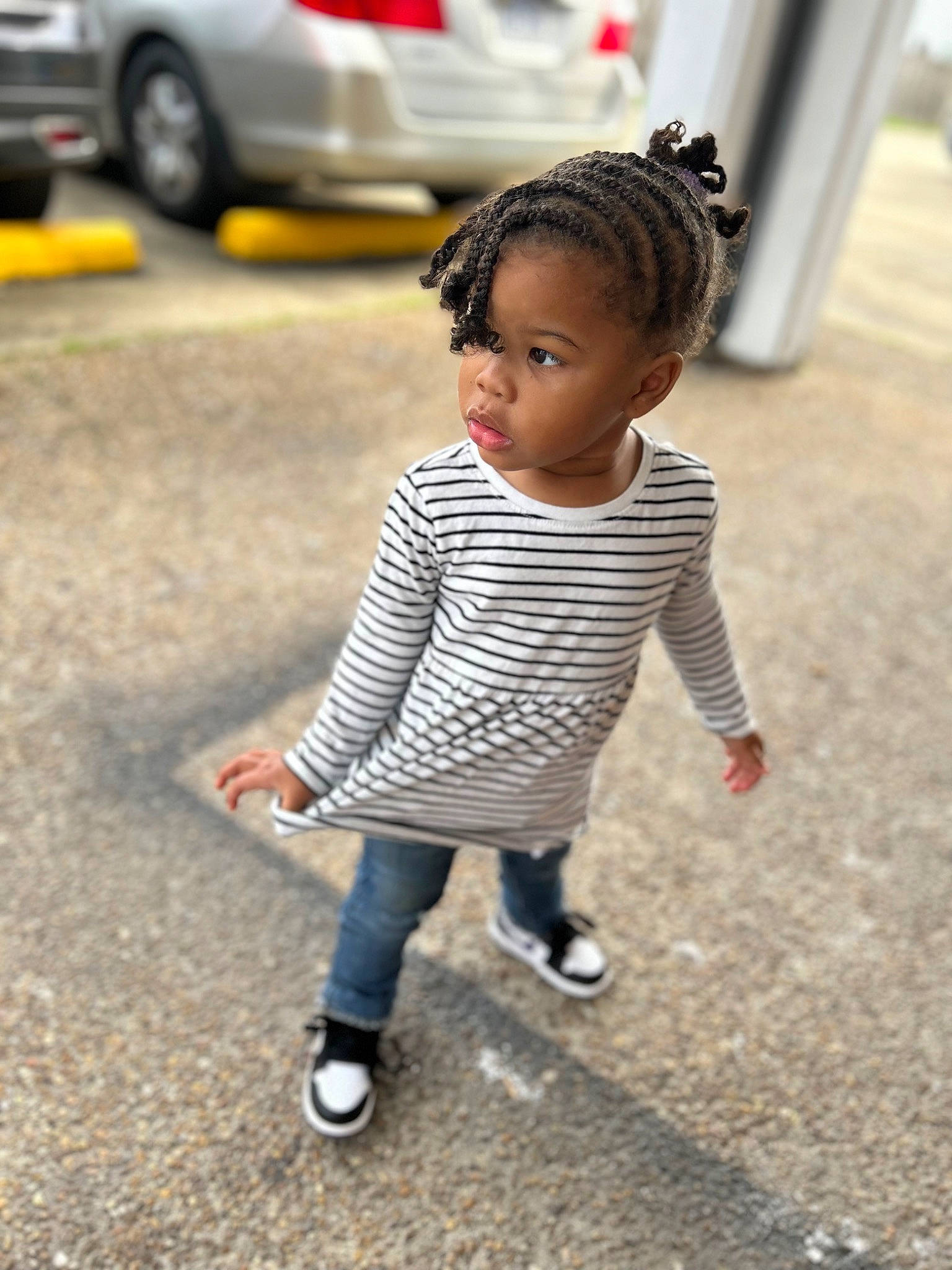 Armani is registered to the contest to win money with this photo: asphalt, automotive_exterior, automotive_lighting, automotive_tire, bumper, child, eye, face, footwear, fun, happy, head, human_body, motor_vehicle, person, recreation, road, road_surface, smile, toddler