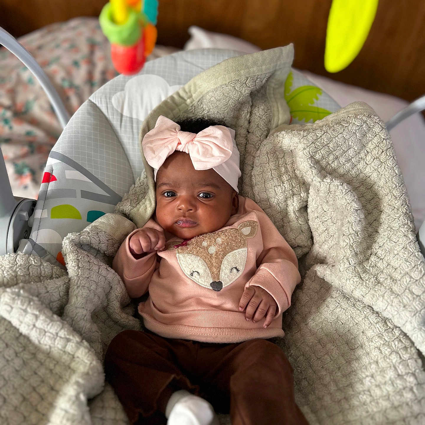 Reumani joined the competition — help win amazing prizes! baby, baby_seat, blanket, brown_pants, child, colorful, cozy, cute, dangle, fox_design, headband, indoor, infant, portrait, relaxed, soft_texture, sweater, toy, white_socks, wooden_background