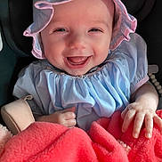 Eldena joined the competition — help win amazing prizes! baby, infant, smile, happy, clothing, bonnet, dress, blanket, hand, face, child, cute, indoors, portrait, person, babywear, seat, human, joy, soft