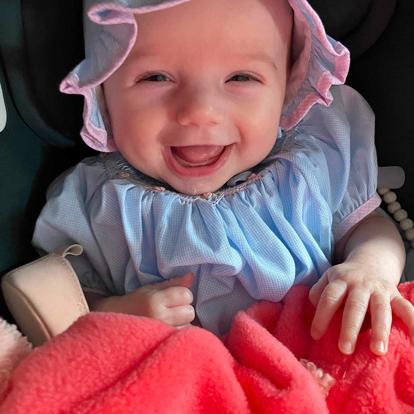 Eldena joined the competition — help win amazing prizes! baby, infant, smile, happy, clothing, bonnet, dress, blanket, hand, face, child, cute, indoors, portrait, person, babywear, seat, human, joy, soft