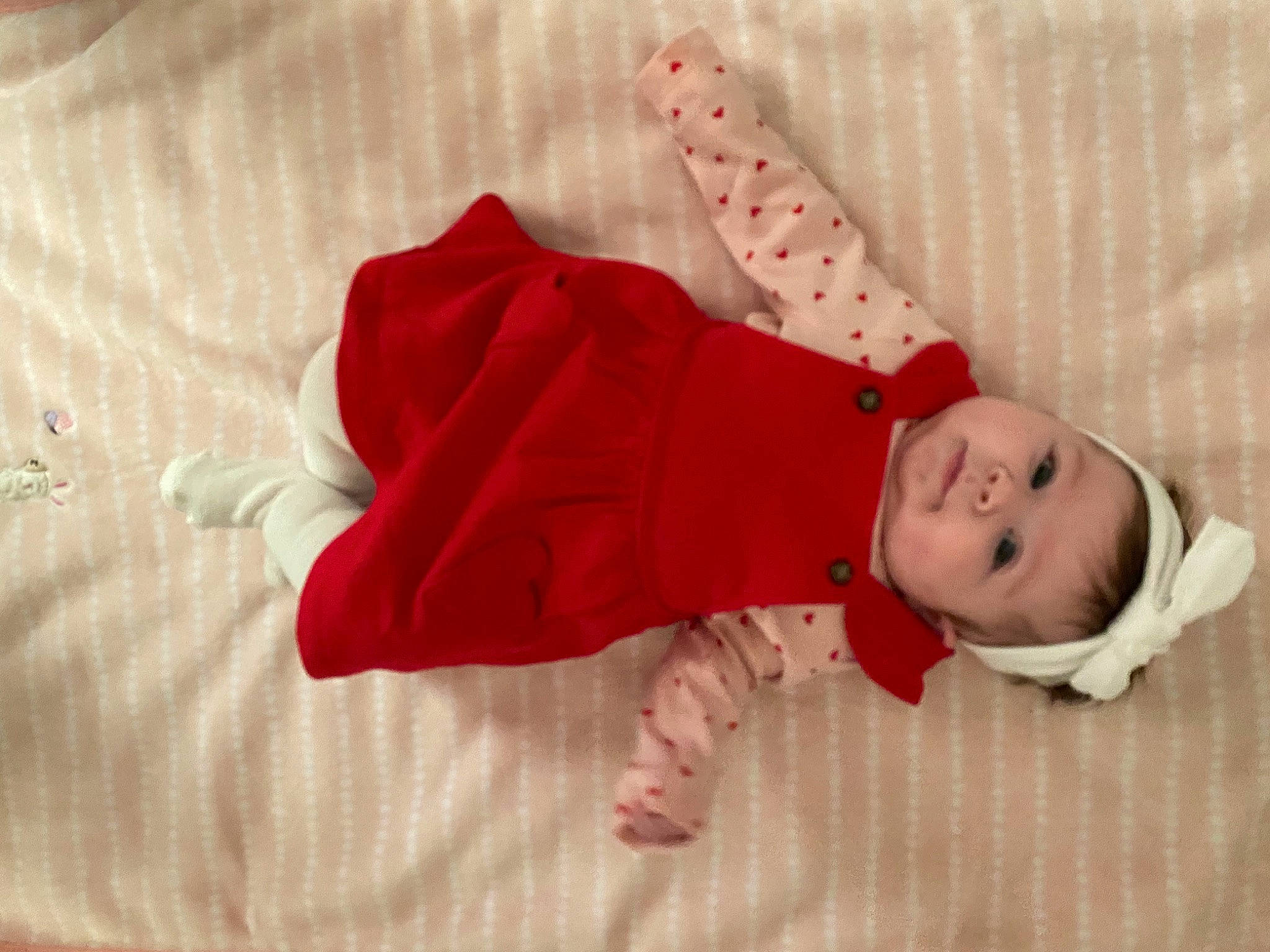 Eloise is registered to the contest to win money with this photo: baby, baby_products, baby_toddler_clothing, carmine, child, comfort, eye, fashion_accessory, flooring, foot, head, headgear, human_body, leg, linens, outerwear, pattern, person, sleeve, toddler