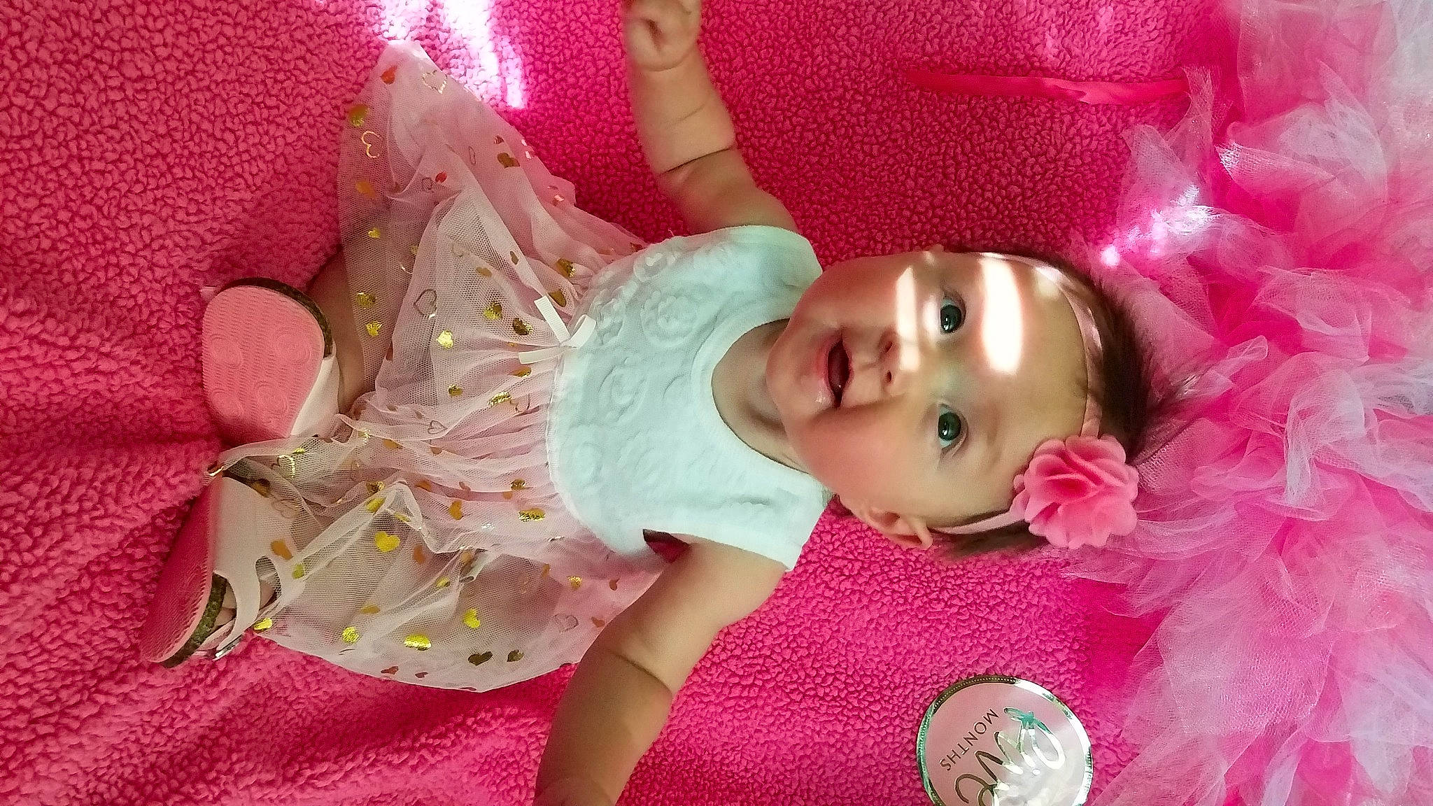 Evelynn is registered to the contest to win money with this photo: baby, baby_toddler_clothing, cheek, child, dress, eye, eyelash, facial_expression, fun, happy, head, iris, lip, magenta, person, pink, product, purple, skin, textile