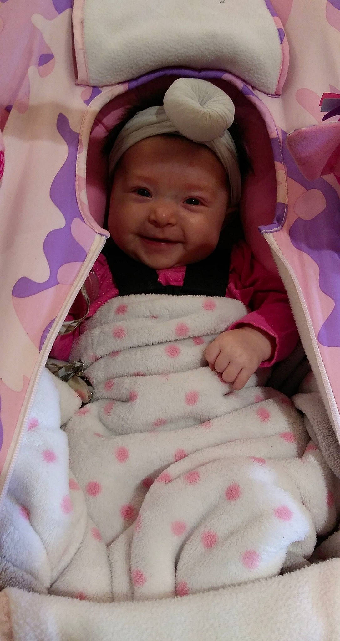 Evelynn is registered to the contest to win money with this photo: baby, baby_toddler_clothing, cheek, child, comfort, eye, facial_expression, finger, happy, headwear, joy, lip, mouth, outerwear, person, pink, purple, skin, sleeve, smile